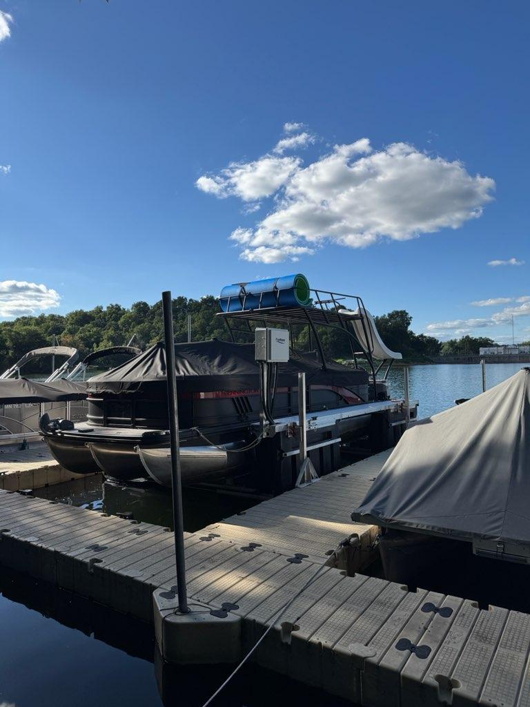 Pontoon boat sitting level on a floating lift